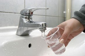 filling a glass with water from a bathroom facet