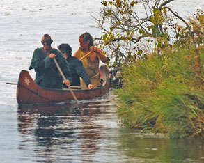 indians paddle along the hudson river
