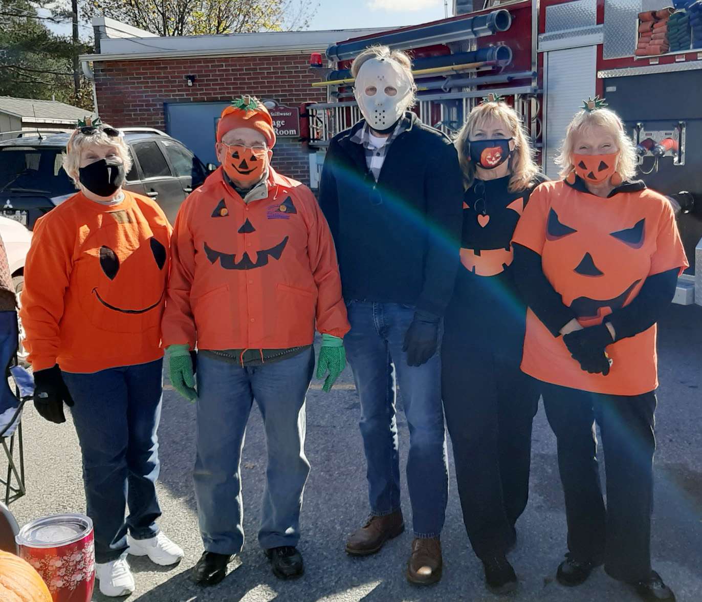 five village trustees dressed as pumpkins for Halloween
