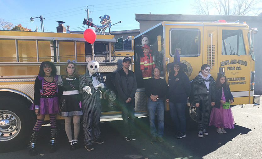 group of people in front of a fire truck